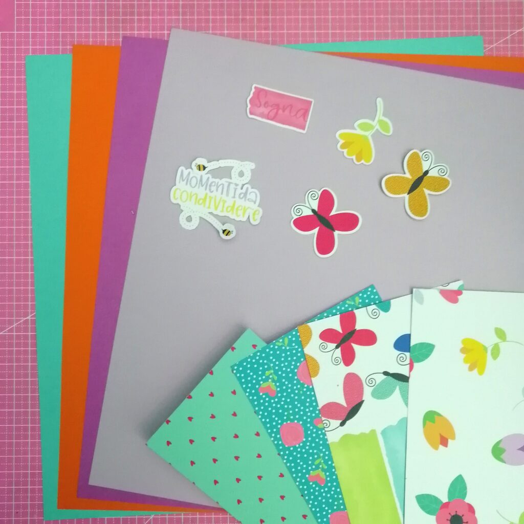 materiali scrapbooking: carta fantasia (carta patterned) cartoncini colorati elementi decorativi di vario genere immagini pretagliate o da ritagliare