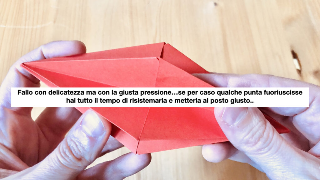 mani che piegano carta per decorazioni di Natale fai-a-te